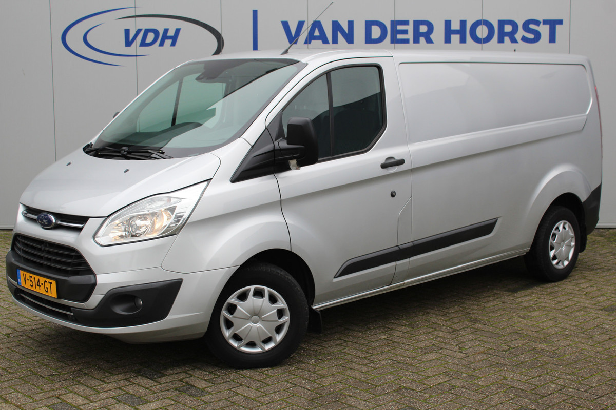 Ford Transit Custom 290 2.0-105pk TDCI L2H1 Trend. Nette Ford Custom in de verlengde uitvoering, deze wagen kan u nog jaren tot dienst zijn. Airco, navigatie, telefoonvoorb., voorraamverwarming, lane assist, parkeersensoren v+a, camera, trekhaak, metallic lak, 3-zits etc.