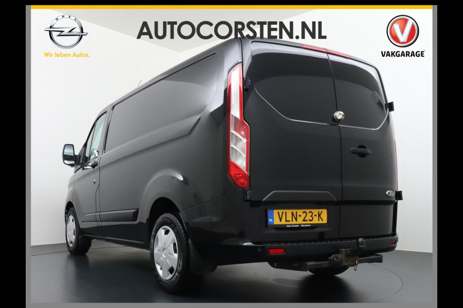 Ford Transit Custom 2.0D 130PK L1H1 3pers. Airco PDC-a+v Trekhaak Cruise-Controle voorruit verwarmbaar Betonplex Schuifdeur-r Tussenwand voorruit ve Adaptieve bochtverl. Projector-koplamp mistlampen regen-/lichtsensor Dieselroetfilter Supervergrendeling EURO 6 385Nm 2.500kg Trekvermogen!