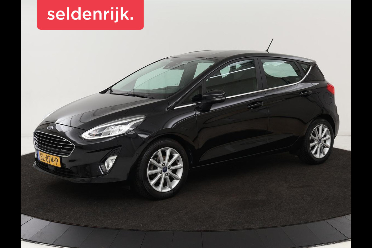 Ford Fiesta 1.0 EcoBoost Titanium | Stoel & stuurverwarming | B&O Sound | Adaptive cruise | Camera | Carplay | Park Assist | Navigatie | Climate control Ford Fiesta 1.0 EcoBoost Titanium | Stoel & stuurverwarming | B&O Sound | Adaptive cruise | Camera | Carplay | Park Assist | Navigatie | Climate control