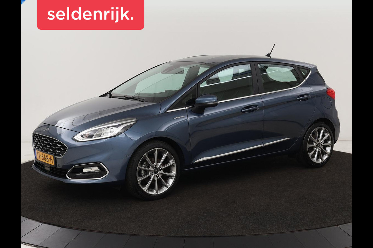 Ford Fiesta 1.0 EcoBoost Vignale | 125pk | Stoel & stuurverwarming | Half leder | B&O Sound | Trekhaak | Carplay | Keyless | Camera | Climate control | Park Assist | Cruise control | Navigatie Ford Fiesta 1.0 EcoBoost Vignale | 125pk | Stoel & stuurverwarming | Half leder | B&O Sound | Trekhaak | Carplay | Keyless | Camera | Climate control | Park Assist | Cruise control | Navigatie