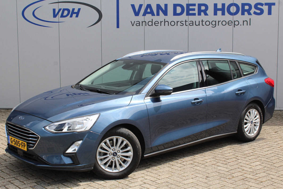 Ford FOCUS Wagon 1.0-125pk EcoBoost Titanium Business. Ruime, zeer geschikte gezinsauto ! Autm. airco dual, stoel-, stuur- en voorraamverw., LM wielen, trekhaak, metallic lak, navigatie, telefoonvoorb., cruise control etc Ford FOCUS Wagon 1.0-125pk EcoBoost Titanium Business. Ruime, zeer geschikte gezinsauto ! Autm. airco dual, stoel-, stuur- en voorraamverw., LM wielen, trekhaak, metallic lak, navigatie, telefoonvoorb., cruise control etc