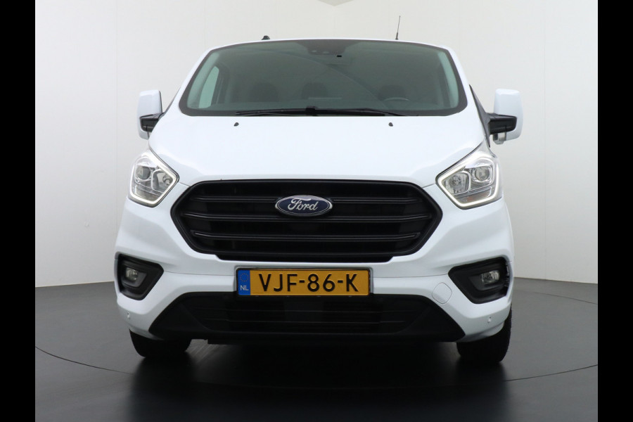 Ford Transit Custom 280 2.0TDCI 130PK L1H1 3-Persoons Apple Carplay Android Auto Airco Trekhaak Camera Cruise Control Pdc Voorruitverwarming Trend Regen-Lichtsensor Betonplex Vloer Wandbetimmering Schuifdeur Euro 6 385NM Koppel Zeer Compleet!