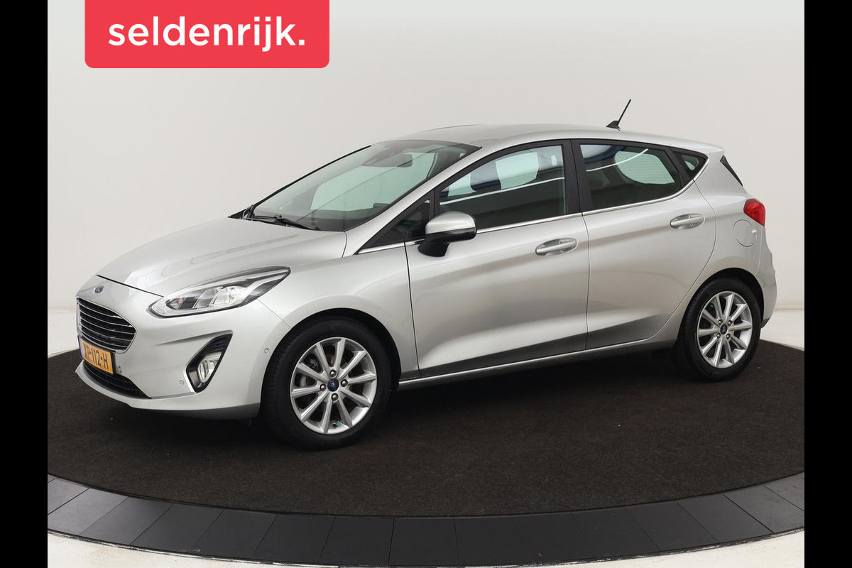 Ford Fiesta 1.0 EcoBoost Titanium | Carplay | Navigatie | DAB | LED | Camera | Cruise Controle | Airco | LMV 16 inch | Lane Assist Ford Fiesta 1.0 EcoBoost Titanium | Carplay | Navigatie | DAB | LED | Camera | Cruise Controle | Airco | LMV 16 inch | Lane Assist