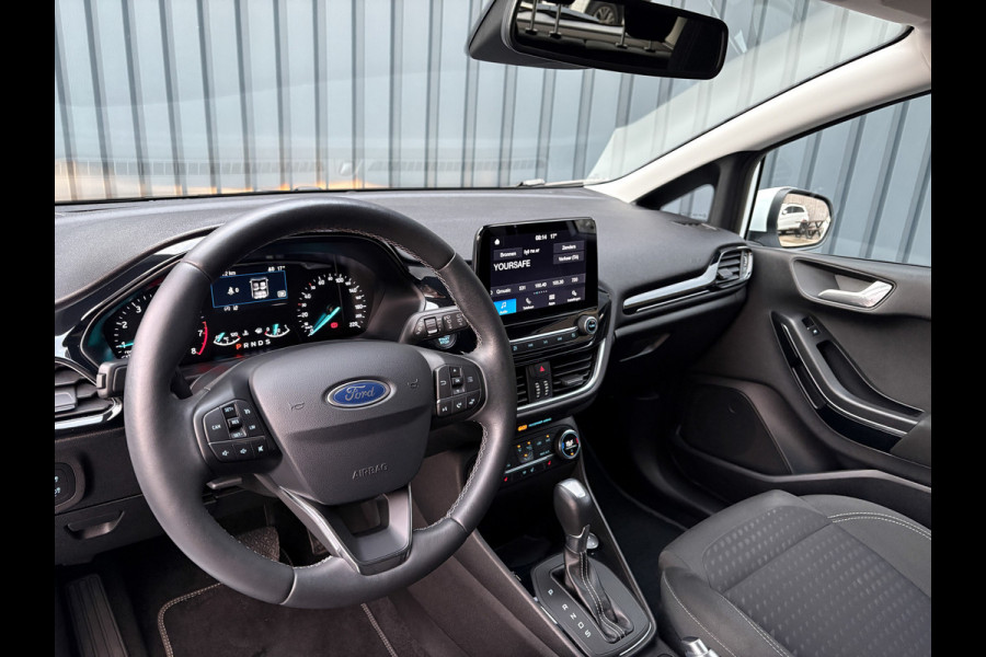 Ford Fiesta 1.0 EcoB. Aut. Titanium | Trekhaak | Stoel & Stuur verw. | Camera | Navi | PDC V&A | Prijs Rijklaar!! Ford Fiesta 1.0 EcoB. Aut. Titanium | Trekhaak | Stoel & Stuur verw. | Camera | Navi | PDC V&A | Prijs Rijklaar!!