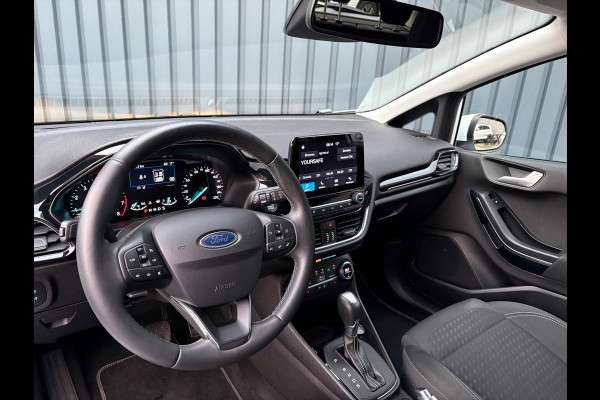 Ford Fiesta 1.0 EcoB. Aut. Titanium | Trekhaak | Stoel & Stuur verw. | Camera | Navi | PDC V&A | Prijs Rijklaar!! Ford Fiesta 1.0 EcoB. Aut. Titanium | Trekhaak | Stoel & Stuur verw. | Camera | Navi | PDC V&A | Prijs Rijklaar!!