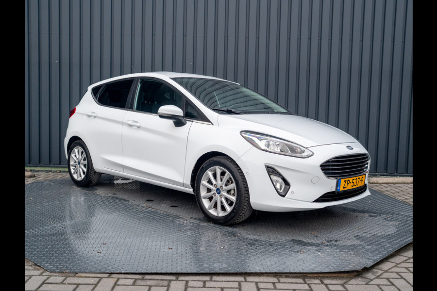 Ford Fiesta 1.0 EcoB. Aut. Titanium | Trekhaak | Stoel & Stuur verw. | Camera | Navi | PDC V&A | Prijs Rijklaar!! Ford Fiesta 1.0 EcoB. Aut. Titanium | Trekhaak | Stoel & Stuur verw. | Camera | Navi | PDC V&A | Prijs Rijklaar!!