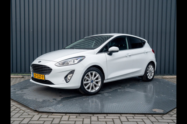 Ford Fiesta 1.0 EcoB. Aut. Titanium | Trekhaak | Stoel & Stuur verw. | Camera | Navi | PDC V&A | Prijs Rijklaar!! Ford Fiesta 1.0 EcoB. Aut. Titanium | Trekhaak | Stoel & Stuur verw. | Camera | Navi | PDC V&A | Prijs Rijklaar!!