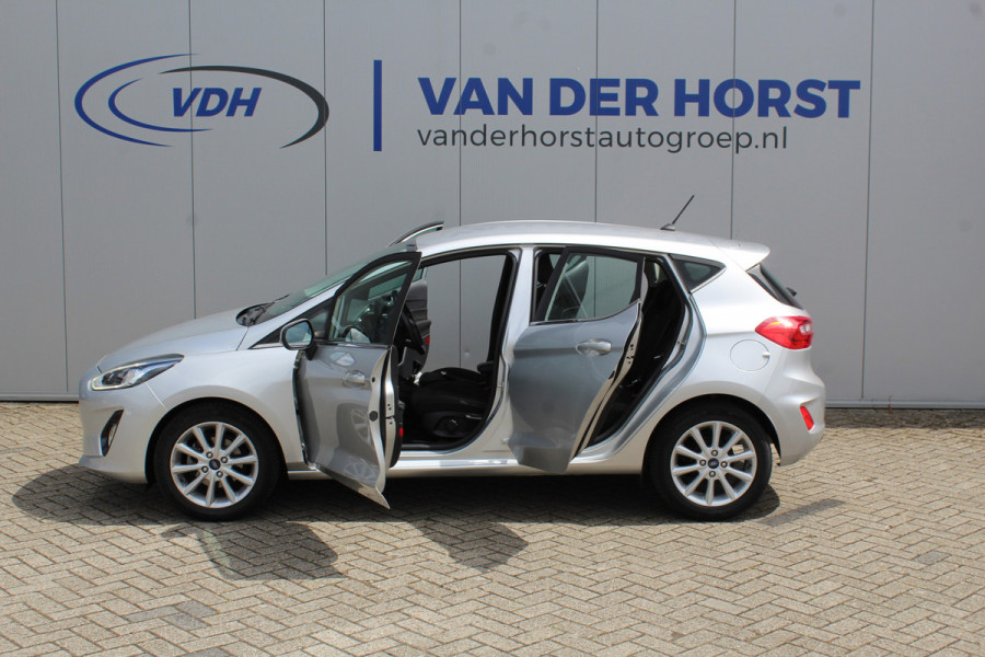 Ford Fiesta 1.0-100pk EcoBoost Titanium 5drs. Uiterst nette, luxe en zuinige Ford Fiesta. Voalautm. airco, Cruise control, Navigatie, LM wielen, Metallic lak, Parkeersensoren achter, Telefoonvoorb., Lane assist etc.
