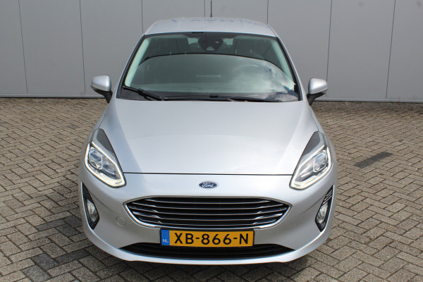 Ford Fiesta 1.0-100pk EcoBoost Titanium 5drs. Uiterst nette, luxe en zuinige Ford Fiesta. Voalautm. airco, Cruise control, Navigatie, LM wielen, Metallic lak, Parkeersensoren achter, Telefoonvoorb., Lane assist etc.