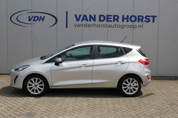 Ford Fiesta 1.0-100pk EcoBoost Titanium 5drs. Uiterst nette, luxe en zuinige Ford Fiesta. Voalautm. airco, Cruise control, Navigatie, LM wielen, Metallic lak, Parkeersensoren achter, Telefoonvoorb., Lane assist etc.