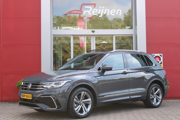 Volkswagen Tiguan 1.4 TSI 245PK eHybrid R-LINE BUSINESS + | BEKLEDING LEDER VIENNA | PANORAMISCH SCHUIF/KANTEL DAK | ELEKTRISCH WEGKLAPENBARE TREKHAAK | R-LINE INTERIEUR/EXTERIEUR | VERWARMBARE VOORSTOELEN/STUUR | ELEKTRISCH BEDIENBARE VOORSTOELEN MET GEHEUGEN FUNCTIE | AKOESTISCH GLAS GETINT | KEYLESS ACCESS/START | ELEKTRISCH BEDIENABRE ACHTERKLEP | DAKSPOILER R-LINE | SFEER VERLICHTING | RIJASSISTENT PAKKET O.A. LANE ASSIST EN ADAPTIVE CRUISE CONTROL EN DODEHOEK DETECTIE | NAVIGATIE | APPLE CARPLAY/ANDROID AUTO | DAB+ RADIO | LED MATRIX KOPLAMPEN (IQ LIGHT) | DRAADLOZE TELEFOONLADER