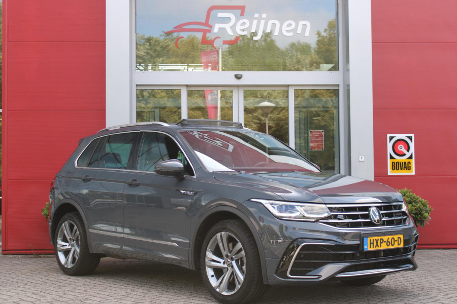 Volkswagen Tiguan 1.4 TSI 245PK eHybrid R-LINE BUSINESS + | BEKLEDING LEDER VIENNA | PANORAMISCH SCHUIF/KANTEL DAK | ELEKTRISCH WEGKLAPENBARE TREKHAAK | R-LINE INTERIEUR/EXTERIEUR | VERWARMBARE VOORSTOELEN/STUUR | ELEKTRISCH BEDIENBARE VOORSTOELEN MET GEHEUGEN FUNCTIE | AKOESTISCH GLAS GETINT | KEYLESS ACCESS/START | ELEKTRISCH BEDIENABRE ACHTERKLEP | DAKSPOILER R-LINE | SFEER VERLICHTING | RIJASSISTENT PAKKET O.A. LANE ASSIST EN ADAPTIVE CRUISE CONTROL EN DODEHOEK DETECTIE | NAVIGATIE | APPLE CARPLAY/ANDROID AUTO | DAB+ RADIO | LED MATRIX KOPLAMPEN (IQ LIGHT) | DRAADLOZE TELEFOONLADER