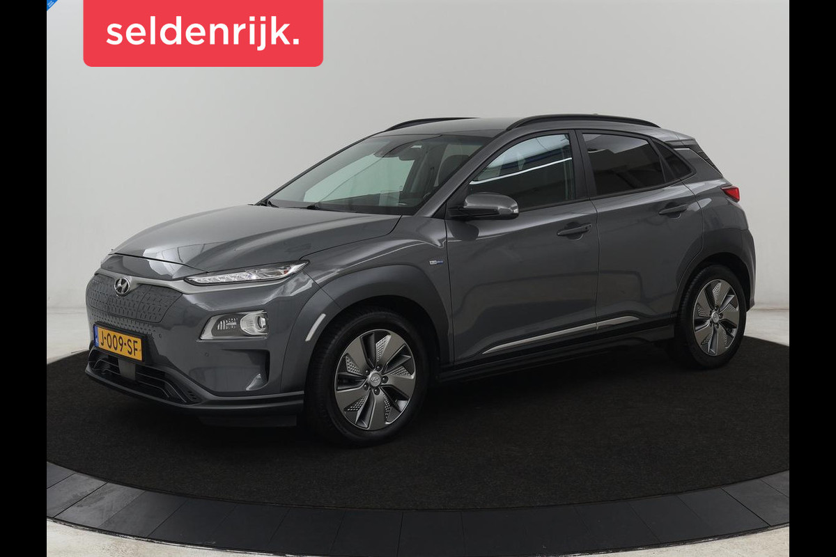 Hyundai Kona EV Premium 64 kWh | SOH 100% | 3 Fase | Stoelventilatie | Leder | Head-Up | Warmtepomp | Camera | Achterbankverwarming | Carplay | Navigatie | Adaptive cruise | Keyless | Parkeerhulp