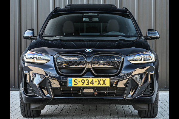 BMW iX3 High Executive 80 kWh M-Sport | Soh 100% | Facelift | Panoramadak | Comfort access | Trekhaak | Shadow-line | Sport seats | Active cruise | 360 camera | Head-up | Harman/Kardon