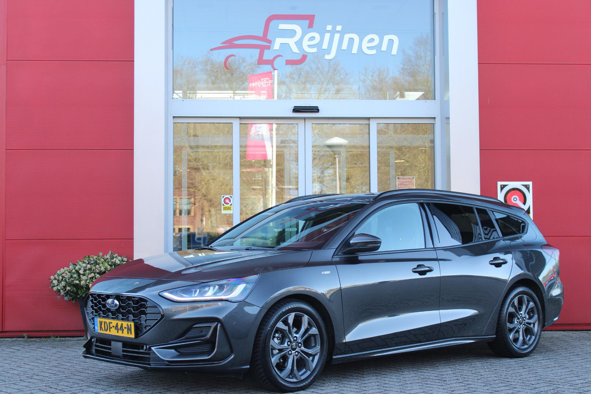 Ford FOCUS Wagon 1.0 155PK AUTOMAAT Hybrid ST LINE | ALL SEASON BANDEN | NAVIGATIE | DRAADLOZE APPLE CARPLAY/ANDROID AUTO | ADAPTIVE CRUISE CONTROL | LANE ASSIST | DODEHOEK DETECTIE | PARKEERSENSOREN VOOR + ACHTER | ACHTERUITRIJ CAMERA | LICHTMETALEN VELGEN 17" | DAB+ RADIO |