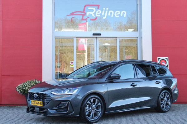 Ford FOCUS Wagon 1.0 155PK AUTOMAAT Hybrid ST LINE | ALL SEASON BANDEN | NAVIGATIE | DRAADLOZE APPLE CARPLAY/ANDROID AUTO | ADAPTIVE CRUISE CONTROL | LANE ASSIST | DODEHOEK DETECTIE | PARKEERSENSOREN VOOR + ACHTER | ACHTERUITRIJ CAMERA | LICHTMETALEN VELGEN 17" | DAB+ RADIO |