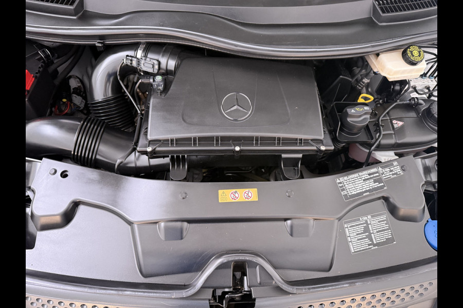 Mercedes-Benz Vito 114CDI 136pk AUT-7 Lang Trekhaak Euro-6 Airco Cruise Control Bluetooth Lane Asist Pdc Betonplex Vloer Wandbetimmering Kast inbouw Achter+Geblindeerde-Raam Schuifdeur 1e Eigenaar 2.000KG Trekgewicht Nette Bus!