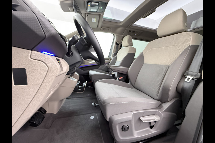 Volkswagen Multivan Bulli 218PK eHybrid AUT-6 Pano-Dak Navi 3-Zone Ecc Cruise Control Camera Trekhaak Apple Carplay Android Pdc Stoelverwarming Life 2+2+2 Premium Zitopstelling Keyless Lmv 19" Easy Open Pack Privacy Glas Elek.Achterklep Led Origineel Nederlandse Bus Dealeronderhouden 1.600kg trekvermogen