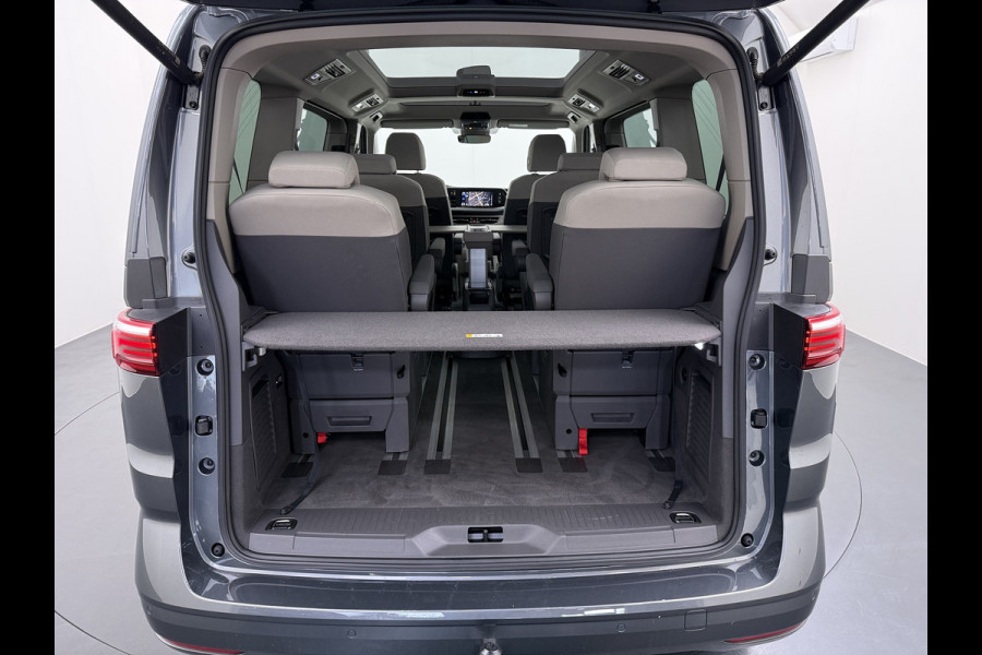 Volkswagen Multivan Bulli 218PK eHybrid AUT-6 Pano-Dak Navi 3-Zone Ecc Cruise Control Camera Trekhaak Apple Carplay Android Pdc Stoelverwarming Life 2+2+2 Premium Zitopstelling Keyless Lmv 19" Easy Open Pack Privacy Glas Elek.Achterklep Led Origineel Nederlandse Bus Dealeronderhouden 1.600kg trekvermogen