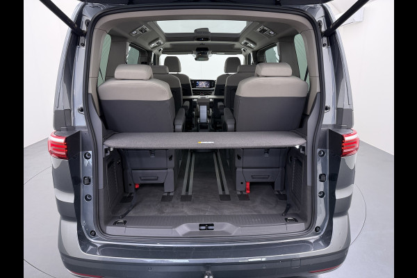 Volkswagen Multivan Bulli 218PK eHybrid AUT-6 Pano-Dak Navi 3-Zone Ecc Cruise Control Camera Trekhaak Apple Carplay Android Pdc Stoelverwarming Life 2+2+2 Premium Zitopstelling Keyless Lmv 19" Easy Open Pack Privacy Glas Elek.Achterklep Led Origineel Nederlandse Bus Dealeronderhouden 1.600kg trekvermogen