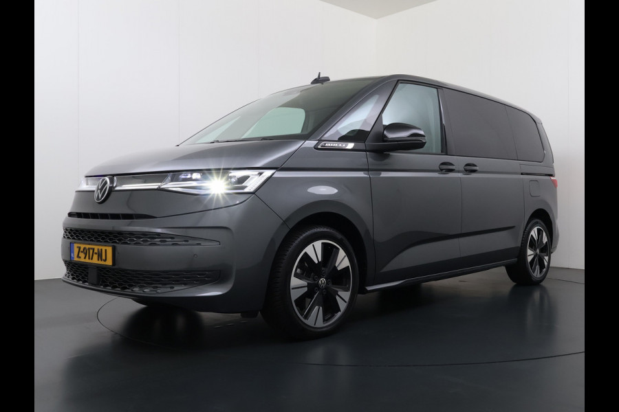 Volkswagen Multivan Bulli 218PK eHybrid AUT-6 Pano-Dak Navi 3-Zone Ecc Cruise Control Camera Trekhaak Apple Carplay Android Pdc Stoelverwarming Life 2+2+2 Premium Zitopstelling Keyless Lmv 19" Easy Open Pack Privacy Glas Elek.Achterklep Led Origineel Nederlandse Bus Dealeronderhouden 1.600kg trekvermogen