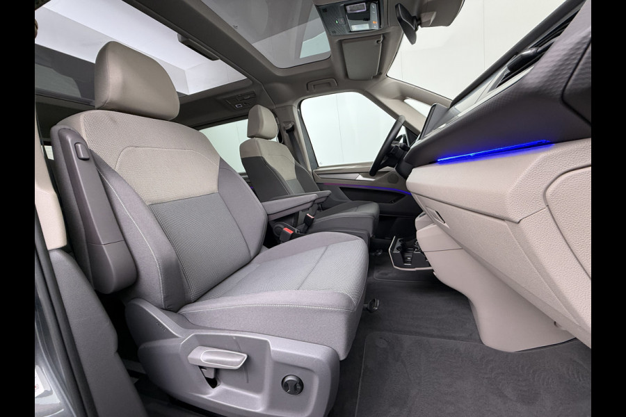 Volkswagen Multivan Bulli 218PK eHybrid AUT-6 Pano-Dak Navi 3-Zone Ecc Cruise Control Camera Trekhaak Apple Carplay Android Pdc Stoelverwarming Life 2+2+2 Premium Zitopstelling Keyless Lmv 19" Easy Open Pack Privacy Glas Elek.Achterklep Led Origineel Nederlandse Bus Dealeronderhouden 1.600kg trekvermogen