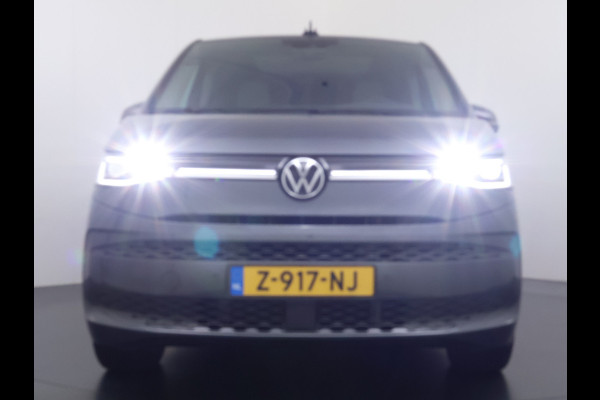 Volkswagen Multivan Bulli 218PK eHybrid AUT-6 Pano-Dak Navi 3-Zone Ecc Cruise Control Camera Trekhaak Apple Carplay Android Pdc Stoelverwarming Life 2+2+2 Premium Zitopstelling Keyless Lmv 19" Easy Open Pack Privacy Glas Elek.Achterklep Led Origineel Nederlandse Bus Dealeronderhouden 1.600kg trekvermogen