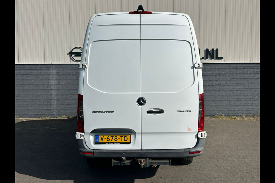 Mercedes-Benz Sprinter 314 2.2 CDI 143pk AUT-7 L2H2 EURO VI-D NAVI Camera ECC Keyless Bluetooth Navigatie-pakket Elektr.Spiegels+Verwarmd BlindSpot-Assist Regensensor Bordherkenning Trekhaak 3.500kg Trekvermogen Betonplex Wandbetimmerd