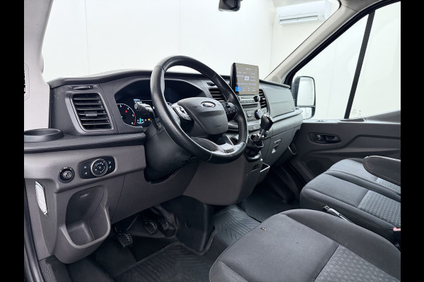 Ford Transit 310 2.0 TDCI L2H2 3-Persoons Camera Airco Stoelverwarming Elek.Stoel Cruise Control Pdc Lane Assist Trend Betonplex Vloer Wandbetimmering Schuifdeur Voorruitverwarming 1e Eigenaar Origineel Nederlandse Bus