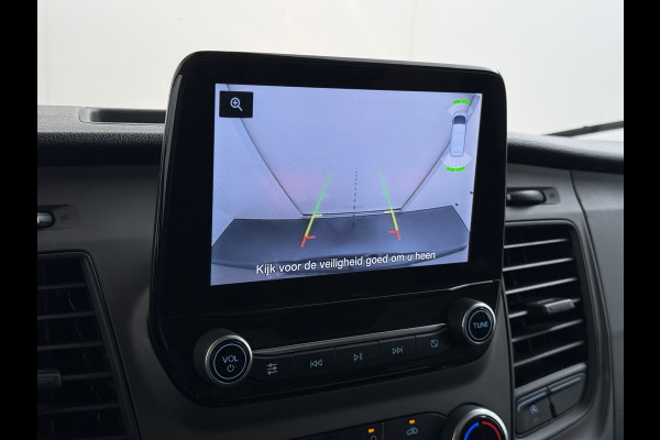Ford Transit 310 2.0 TDCI L2H2 3-Persoons Camera Airco Stoelverwarming Elek.Stoel Cruise Control Pdc Lane Assist Trend Betonplex Vloer Wandbetimmering Schuifdeur Voorruitverwarming 1e Eigenaar Origineel Nederlandse Bus