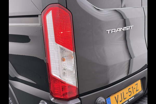 Ford Transit 310 2.0 TDCI L2H2 3-Persoons Camera Airco Stoelverwarming Elek.Stoel Cruise Control Pdc Lane Assist Trend Betonplex Vloer Wandbetimmering Schuifdeur Voorruitverwarming 1e Eigenaar Origineel Nederlandse Bus