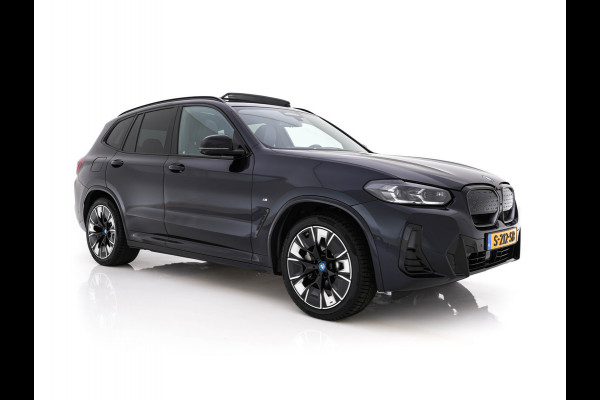 BMW iX3 High Executive 80 kWh Facelift [ 3-Fase-11kW) ] {SOH-100%} (INCL-BTW) Aut. *PANO | LEATHER | ADAPTIVE-CRUISE | FULL-LED | HARMAN/KARDON | TOPVIEW | MEMORY-PACK | BLINDSPOT | DIGI-COCKPIT | HEATED-COMFORTSEATS | DAB+ | NAVI-FULLMAP | HEAD-UP | 20''ALU