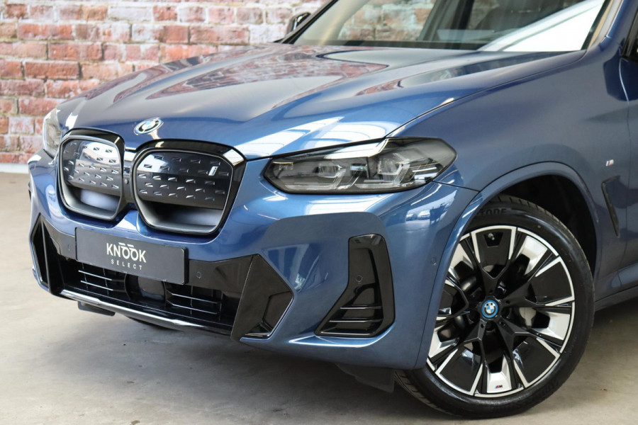 BMW iX3 High Executive M Sport Pakket 80 kWh / Live Cockpit Professional / Active Protection / Driving Assistant Professional / Panoramadak / Trekhaak / Leder / Adaptieve LED-koplamp / Shadow Line / Adaptief Onderstel /  Stuurwielverwarming / Head-Up Display / DAB / Harman Kardon