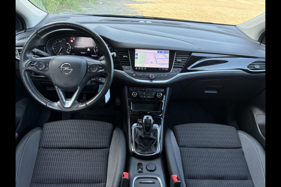 Opel Astra 1.2 Launch Elegance 2e Eigenaar,Camera,Stoelverw-Stuurverw,110pk,Navi,Carplay,Halfleder,Elekt.Stoel,6 Bak,Clima,Cruise,Lm velgen,Pdc V+A,N.A.P,Net beurt gehad,Apk tot 09-2028