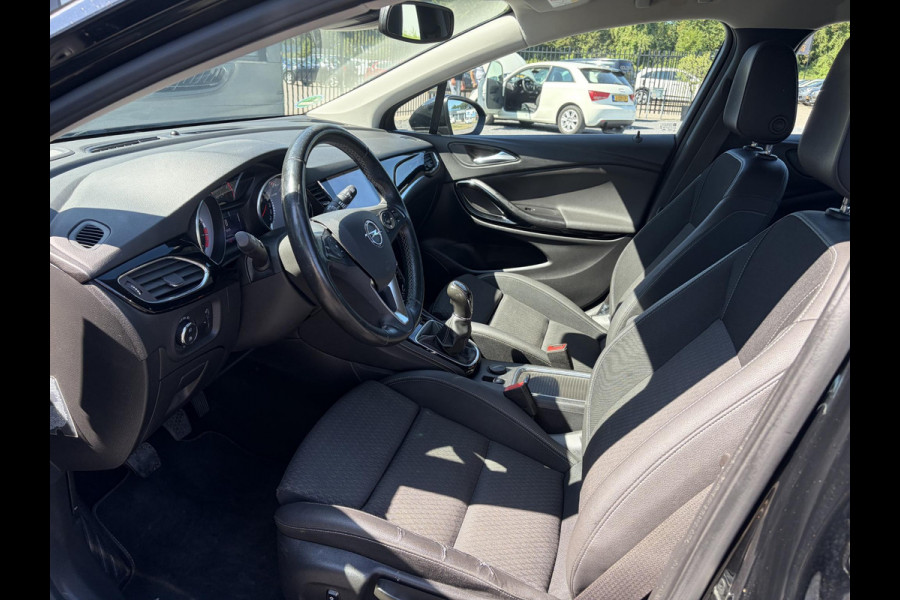 Opel Astra Sports Tourer 1.4 Business Executive 2e Eigenaar l 150pk l Carplay l Navi l Pdc V+A l Stoelvw-Stuurverw l Clima l Cruise l 18''Lmv l Halfleder l 6 Bak l Rijstrooksensor l N.A.P l Apk tot 08-2027