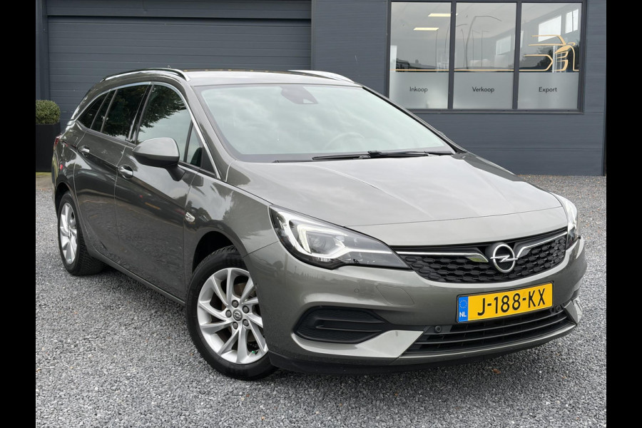 Opel Astra Sports Tourer 1.2 Elegance ✓131pk✓2e Eigenaar✓Camera✓Carplay✓6 Bak✓Stoelverw✓Stuurverw✓Pdc V+A✓Recent beurt gehad✓Clima✓Cruise✓Halfleder✓Keyless✓N.A.P✓Lm velgen✓Rijstrooksensor✓Apk tot 09-2028