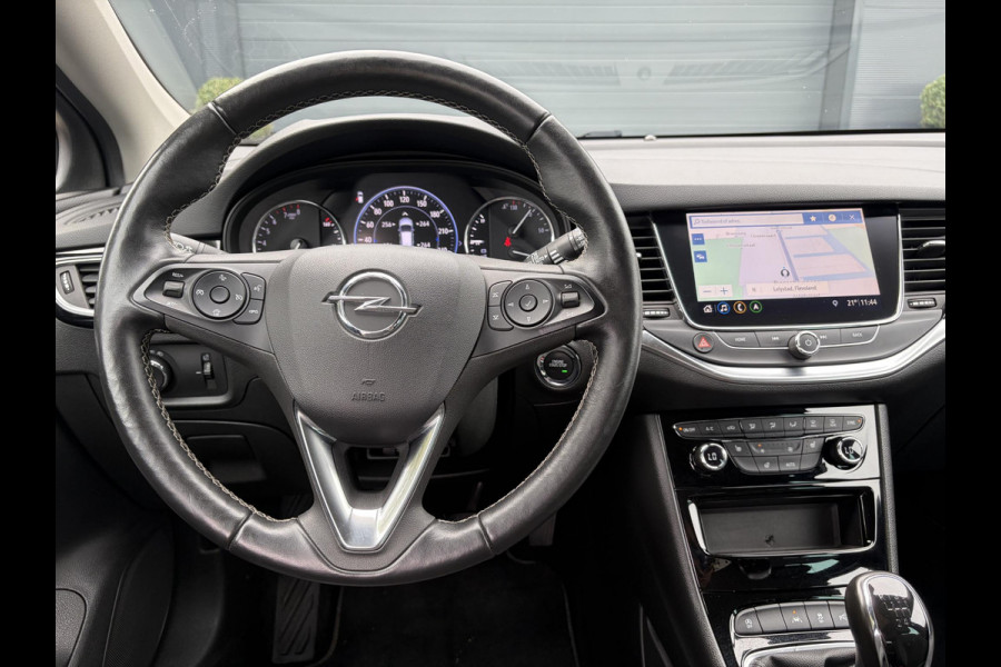 Opel Astra Sports Tourer 1.2 Elegance ✓131pk✓2e Eigenaar✓Camera✓Carplay✓6 Bak✓Stoelverw✓Stuurverw✓Pdc V+A✓Recent beurt gehad✓Clima✓Cruise✓Halfleder✓Keyless✓N.A.P✓Lm velgen✓Rijstrooksensor✓Apk tot 09-2028