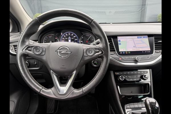 Opel Astra Sports Tourer 1.2 Elegance ✓131pk✓2e Eigenaar✓Camera✓Carplay✓6 Bak✓Stoelverw✓Stuurverw✓Pdc V+A✓Recent beurt gehad✓Clima✓Cruise✓Halfleder✓Keyless✓N.A.P✓Lm velgen✓Rijstrooksensor✓Apk tot 09-2028