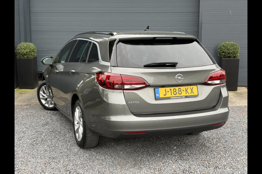 Opel Astra Sports Tourer 1.2 Elegance ✓131pk✓2e Eigenaar✓Camera✓Carplay✓6 Bak✓Stoelverw✓Stuurverw✓Pdc V+A✓Recent beurt gehad✓Clima✓Cruise✓Halfleder✓Keyless✓N.A.P✓Lm velgen✓Rijstrooksensor✓Apk tot 09-2028