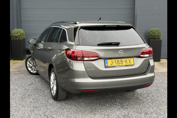 Opel Astra Sports Tourer 1.2 Elegance ✓131pk✓2e Eigenaar✓Camera✓Carplay✓6 Bak✓Stoelverw✓Stuurverw✓Pdc V+A✓Recent beurt gehad✓Clima✓Cruise✓Halfleder✓Keyless✓N.A.P✓Lm velgen✓Rijstrooksensor✓Apk tot 09-2028