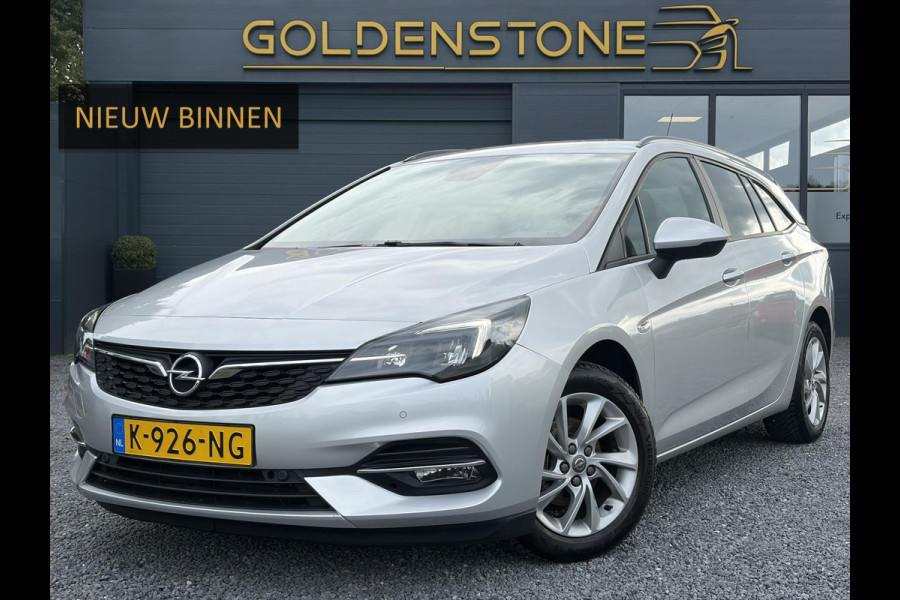 Opel Astra Sports Tourer 1.2 Business Executive ✓1e Eigenaar✓146pk✓Camera✓Trekhaak✓Carplay✓Airco✓Cruise✓Pdc V+A✓Lm velgen✓Comfortstoelen✓6 Bak✓N.A.P✓Nieuwe Apk bij Aflevering