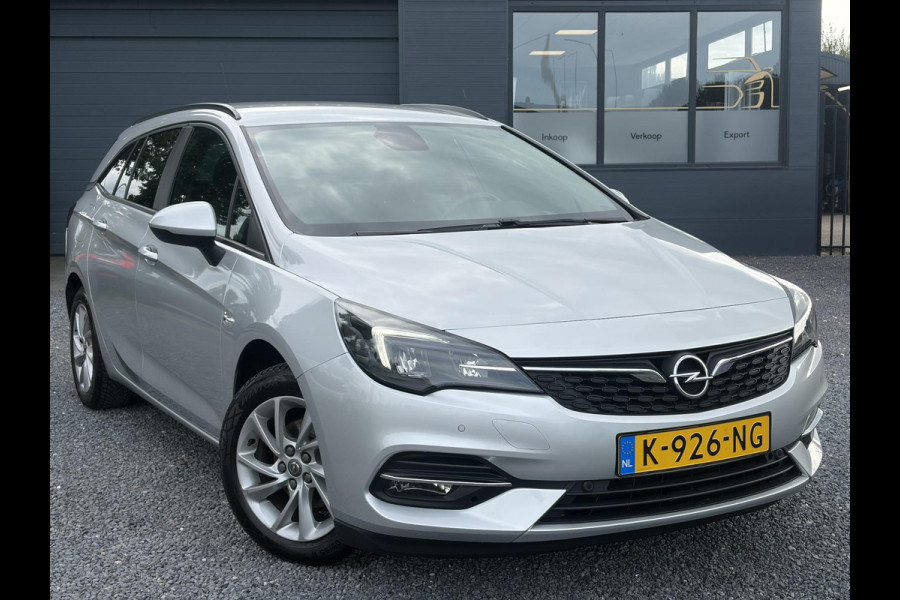 Opel Astra Sports Tourer 1.2 Business Executive ✓1e Eigenaar✓146pk✓Camera✓Trekhaak✓Carplay✓Airco✓Cruise✓Pdc V+A✓Lm velgen✓Comfortstoelen✓6 Bak✓N.A.P✓Nieuwe Apk bij Aflevering