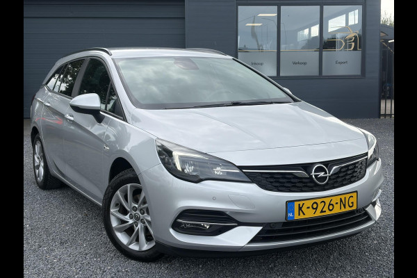 Opel Astra Sports Tourer 1.2 Business Executive ✓1e Eigenaar✓146pk✓Camera✓Trekhaak✓Carplay✓Airco✓Cruise✓Pdc V+A✓Lm velgen✓Comfortstoelen✓6 Bak✓N.A.P✓Nieuwe Apk bij Aflevering
