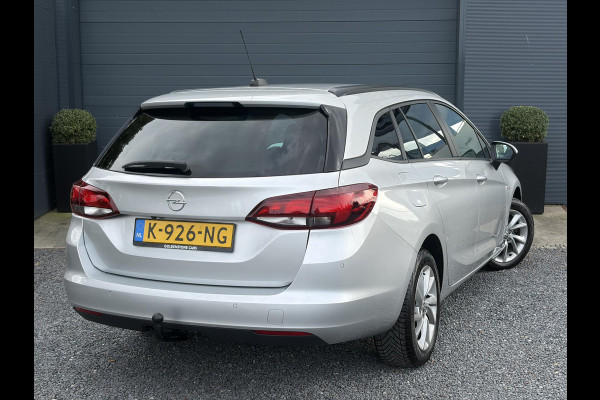 Opel Astra Sports Tourer 1.2 Business Executive ✓1e Eigenaar✓146pk✓Camera✓Trekhaak✓Carplay✓Airco✓Cruise✓Pdc V+A✓Lm velgen✓Comfortstoelen✓6 Bak✓N.A.P✓Nieuwe Apk bij Aflevering