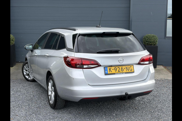 Opel Astra Sports Tourer 1.2 Business Executive ✓1e Eigenaar✓146pk✓Camera✓Trekhaak✓Carplay✓Airco✓Cruise✓Pdc V+A✓Lm velgen✓Comfortstoelen✓6 Bak✓N.A.P✓Nieuwe Apk bij Aflevering