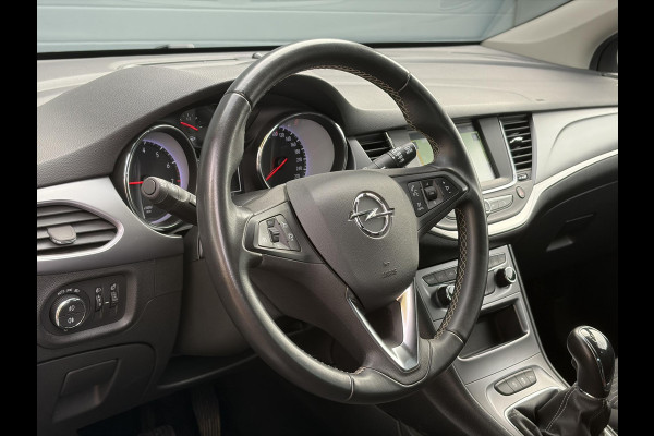Opel Astra Sports Tourer 1.2 Business Executive ✓1e Eigenaar✓146pk✓Camera✓Trekhaak✓Carplay✓Airco✓Cruise✓Pdc V+A✓Lm velgen✓Comfortstoelen✓6 Bak✓N.A.P✓Nieuwe Apk bij Aflevering