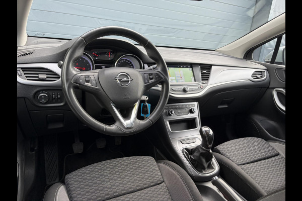 Opel Astra Sports Tourer 1.2 Business Executive ✓1e Eigenaar✓146pk✓Camera✓Trekhaak✓Carplay✓Airco✓Cruise✓Pdc V+A✓Lm velgen✓Comfortstoelen✓6 Bak✓N.A.P✓Nieuwe Apk bij Aflevering
