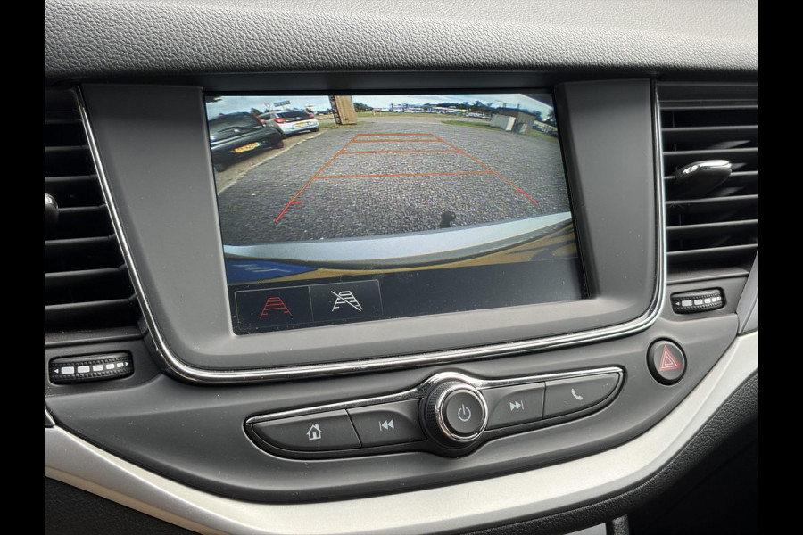 Opel Astra Sports Tourer 1.2 Business Executive ✓1e Eigenaar✓146pk✓Camera✓Trekhaak✓Carplay✓Airco✓Cruise✓Pdc V+A✓Lm velgen✓Comfortstoelen✓6 Bak✓N.A.P✓Nieuwe Apk bij Aflevering