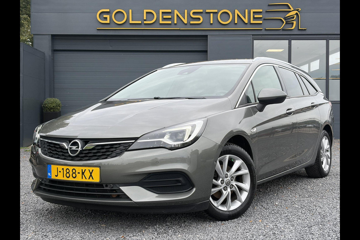 Opel Astra Sports Tourer 1.2 Elegance ✓131pk✓2e Eigenaar✓Camera✓Carplay✓6 Bak✓Stoelverw✓Stuurverw✓Pdc V+A✓Recent beurt gehad✓Clima✓Cruise✓Halfleder✓Keyless✓N.A.P✓Lm velgen✓Rijstrooksensor✓Apk tot 09-2028