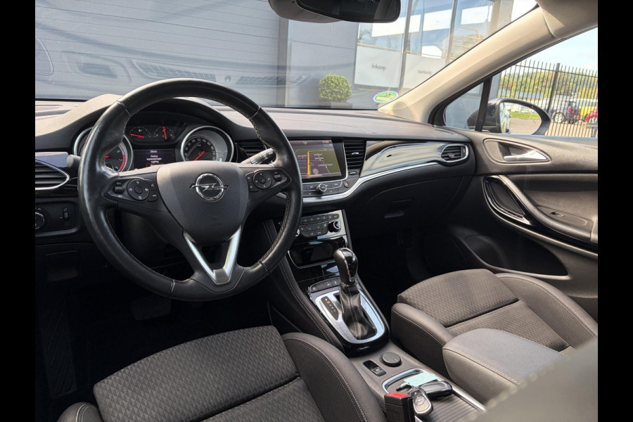 Opel Astra Sports Tourer 1.4 Business Executive ✓2 Eigenaar✓Camera✓Navi✓Trekhaakt✓Carplay✓Stoelverw✓Stuurverw✓Automaat✓Dealer Onderhouden✓Keyless✓Clima✓Cruise✓Pdc V+A✓Halfleder✓Comfortstoelen✓150pk✓Rijstrooksensor✓Dodehoeksensor✓Elekt Stoelen✓Lm velgen✓N.A.P✓Apk tot 03-2027